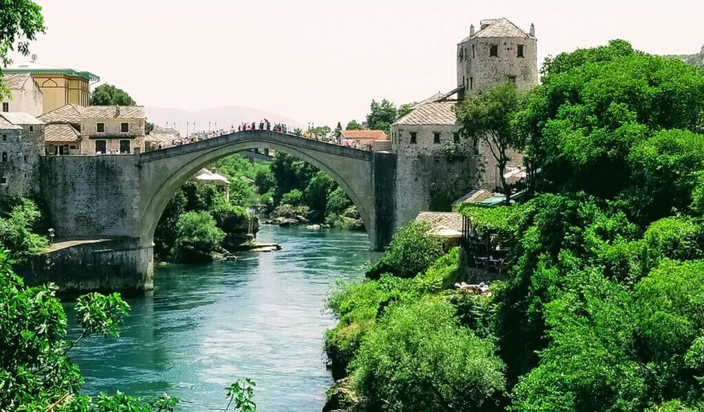 The sand colored Old Bridge in Mostar stands over the beautiful turquoise river.  It is the star attraction and the number one thing to see in the city.  