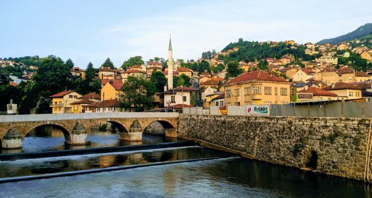 Sarajevo the heart of Bosnia and Herzegovina showing a bridge over the river with mosques in the background