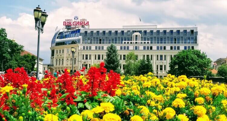 Bulgaria's Grand Hotel with flowers all around it