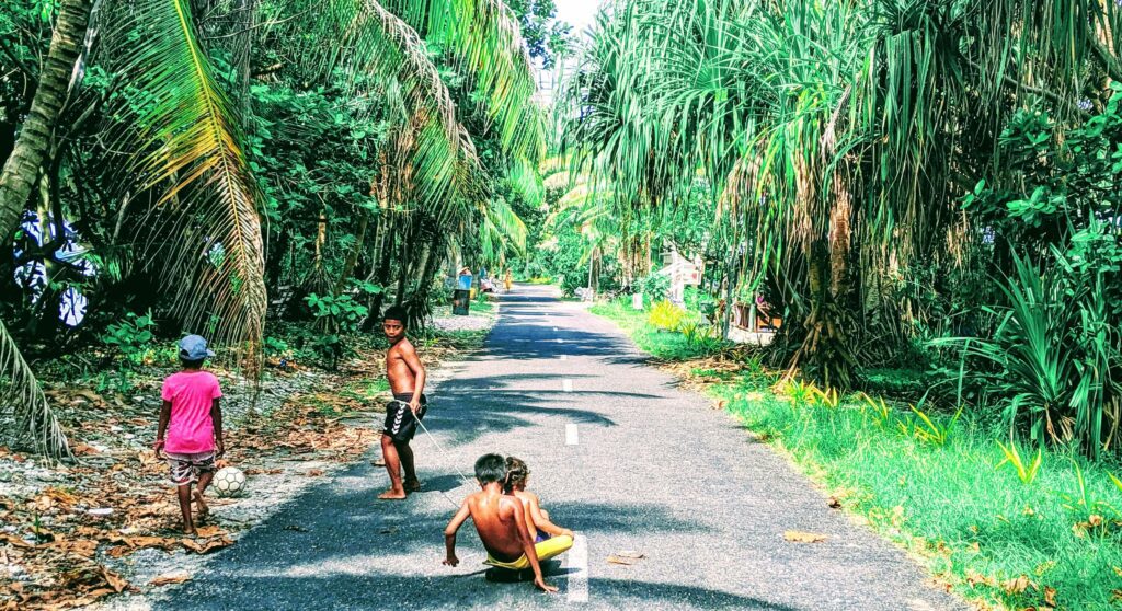 Kids playing on the only road on the Main Atoll